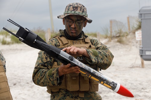 Marine holding a water rocket device